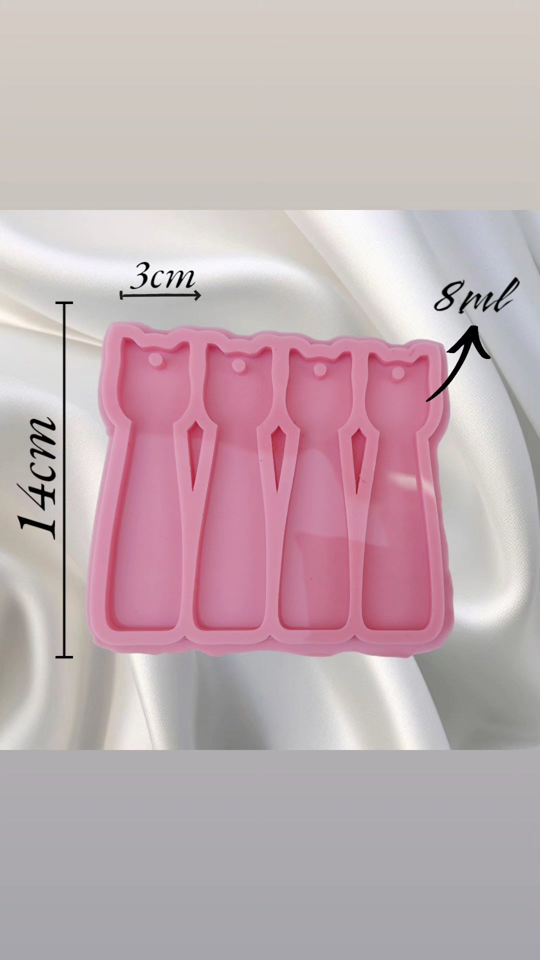 This silicone mold has four cavities in the shape of a cat's head. It can be used for casting resin, wax, or ceramics. The mold is very practical because it saves time by producing four pieces at once with high precision