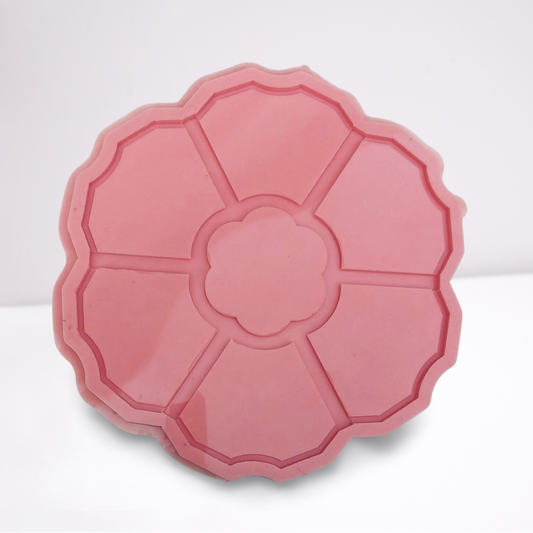 A silicone mold specially designed for artistic casting work such as resin, plaster, or pottery. The mold features a round shape decorated with curved edges resembling the petals of a blooming flower. Size: 30 cm