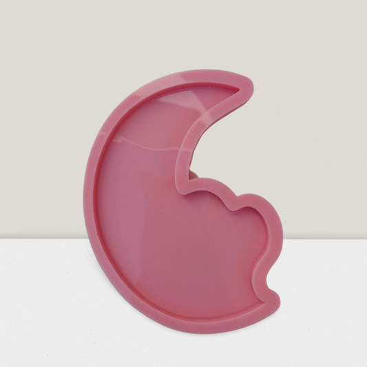A crescent-shaped silicone mold with a heart, designed for crafts such as casting resin, plaster, or pottery. Available in two different sizes.